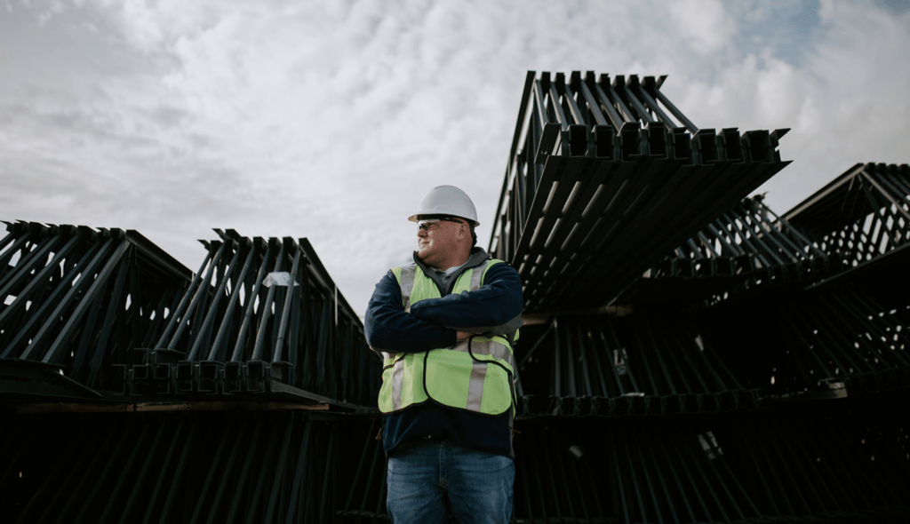 All Phase employee standing in front of equipment for a dramatic scene.